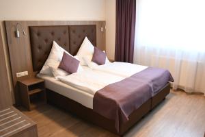 a bedroom with a large bed with a large window at Ata Hotel - Self Check-in in Hamburg