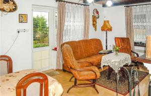 a living room with a couch and a table at Lovely Home In Nowe Warpno With House Sea View in Nowe Warpno