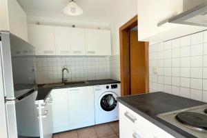 a kitchen with a washing machine and a washer at Equipped Apartment in Düren in Düren - Eifel