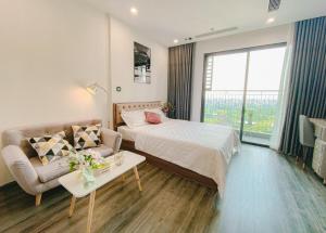 um quarto de hotel com uma cama e um sofá em Apartment 1BR-FL12th-R103 Building-Vinhome Ocean Park em Hanói