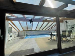 a view of a swimming pool from the window of a house at Ferienhaus Meerzeit in Gelting