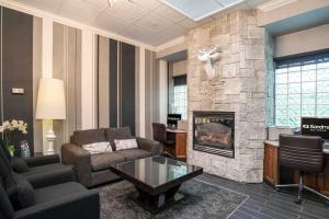 a living room with a couch and a fireplace at Sandman Hotel Revelstoke in Revelstoke