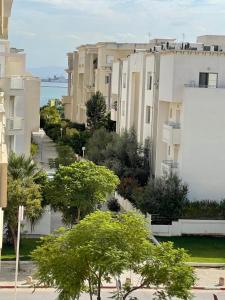 a view of a street with buildings and trees at Bright Flat Lac 2 Tunis in Tunis