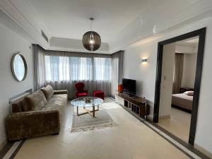 a living room with a couch and a table at Bright Flat Lac 2 Tunis in Tunis