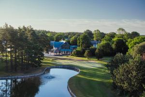 an aerial view of a golf course with a pond at Gumbalde Resort in Stånga