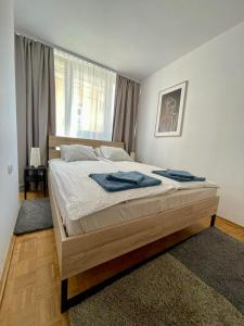 a bedroom with a bed with blue towels on it at Stare Miasto - Trębacka in Warsaw