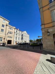 a city street with buildings and a brick sidewalk at Stare Miasto - Trębacka in Warsaw