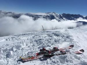 a pair of skis laying in the snow on a mountain at Mountain Sunrise in Bansko