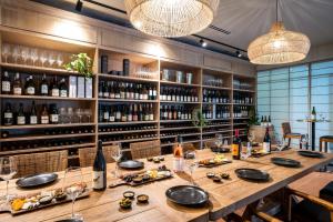a long table in a room with wine bottles at Ein Gev Holiday Resort in Ein Gev