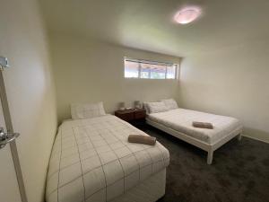 a bedroom with two beds and a window at Private 2 bedrooms suite with free parking in Rotorua