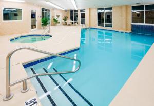 a large swimming pool with blue water in a building at Holiday Inn Express & Suites Asheville Downtown, an IHG Hotel in Asheville