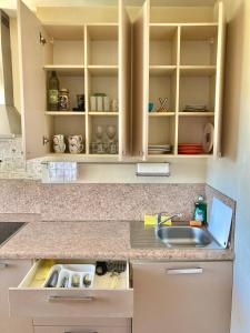 a kitchen with a sink and a counter at Apartment Saharova in Rīga