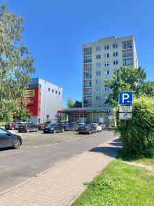a parking lot with a parking sign next to a building at Apartment Saharova in Rīga