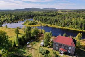 an aerial view of a barn and a river at LappHouse Puistola in Palojoensuu