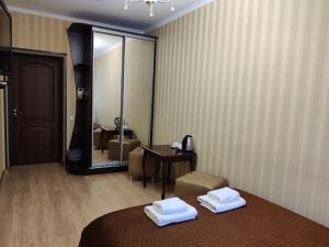 a hotel room with a bed and a mirror at Evropeyskiy in Kyiv