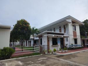 a building with a parking lot in front of it at My Place Resort & Pavilion in Balayan