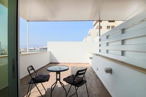 a balcony with a table and chairs on a building at Phaedrus Living: Luxury Suite Nicosia 503 in Nicosia