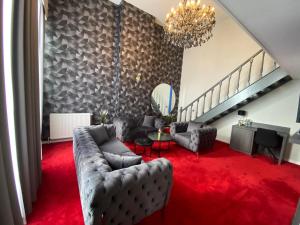 a living room with a couch and a red carpet at La Bourse Hotel in Brussels