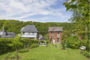 a large yard with a house and a building at L'Hermine in Spa