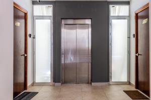 a hallway with three doors in a building at Studios with roofpool in Vanessa 24 in Playa del Carmen