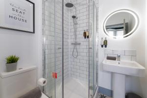 a bathroom with a shower and a sink at The Madison in Southampton