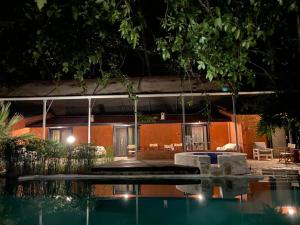 a house with a swimming pool at night at Olympos Five Rooms Apart no 1 in Antalya