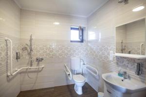 a white bathroom with a sink and a toilet at Kovács tanya - falusi szálláshely in Kunmadaras +26 photos