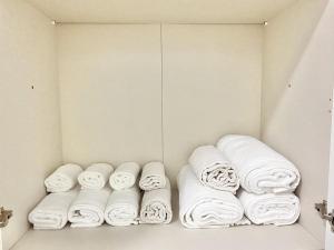 a bunch of towels are lined up in a closet at Pamela House in Noto +11 photos