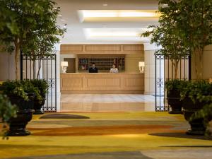 a lobby with a gate with two people in the background at Hotel Francs in Chiba