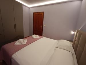 a bedroom with a bed with two towels on it at Moratto's Apartments in Umag