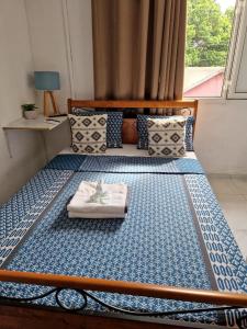 a bedroom with a bed with a blue and white mattress at La Vue De Haut- T3 avec vue imprenable sur la mer in Bouéni