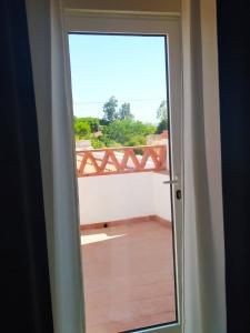 a door with a view of a balcony at Residência D'Atalaia in Fronteira