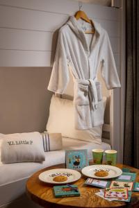 a room with a table with two plates on a bed at Thorpe Park Hotel and Spa in Leeds