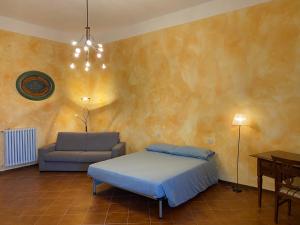 a bedroom with a bed and a chair at CASA DI NONNA RINDA-Via del Castello n6 in Monte Santa Maria Tiberina