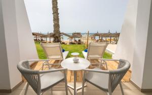 a table and chairs on a balcony with a view of the beach at Royal Azur Thalassa in Hammamet