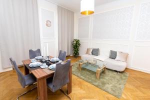 a living room with a table and a couch at SISSI beautifully designed apatment close to main train station in Vienna