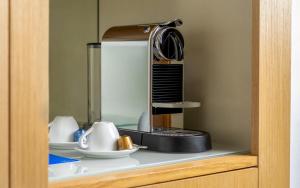 a coffee maker sitting on top of a shelf at Royal Azur Thalassa in Hammamet