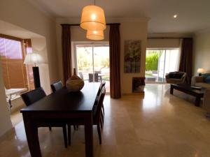 a dining room with a table and chairs and a living room at Villa Fairways Golf By Mila Prieto in Arcos de la Frontera