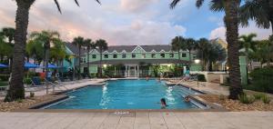 a pool at a resort with people playing in it at My Home in Orlando in Kissimmee