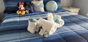 a blue bed with stuffed animals on top of it at My Home in Orlando in Kissimmee +61 photos