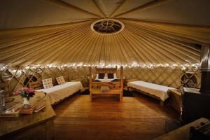 a room with two beds in a yurt at Secret Cloud House Holidays Luxury Yurts with Hot Tubs in Cauldon