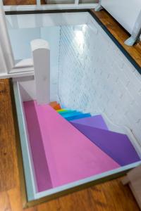 a glass box with colorful floors in a room at ~ Colorful Dream Apartment ~ 2BD in the TOP Center of Sofia in Sofia