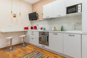 a kitchen with white cabinets and a sink at ~ Colorful Dream Apartment ~ 2BD in the TOP Center of Sofia in Sofia