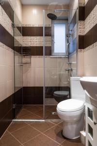 a bathroom with a toilet and a glass shower at ~ Colorful Dream Apartment ~ 2BD in the TOP Center of Sofia in Sofia
