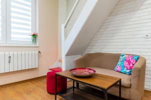 a living room with a couch and a table at ~ Colorful Dream Apartment ~ 2BD in the TOP Center of Sofia in Sofia