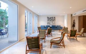 a waiting room with chairs and a blue couch at Royal Azur Thalassa in Hammamet