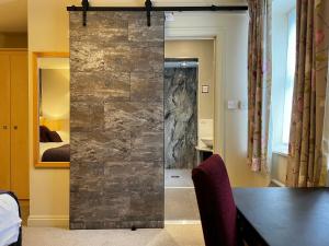 a sliding glass door in a room with a bedroom at Herriots Hotel in Skipton +141 photos