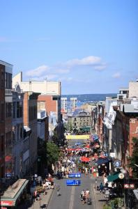 a busy city street with a crowd of people at Le 31 McMahon in Quebec City