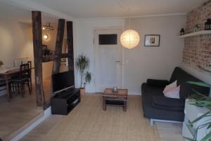 a living room with a couch and a table at Ferienwohnung Holzmaden Am Platz in Holzmaden
