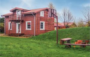 a house on a hill with a bench in front of it at Stunning Home In Ustronie Morskie With 4 Bedrooms And Wifi in Ustronie Morskie